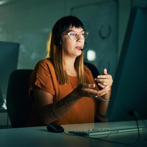 Contact center agent speaks on phone with customer Contact center agent speaks on phone with customer