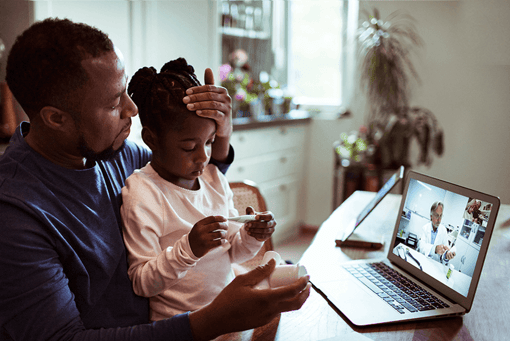 Telehealth Technology A father consulting with a doctor over video with daughter