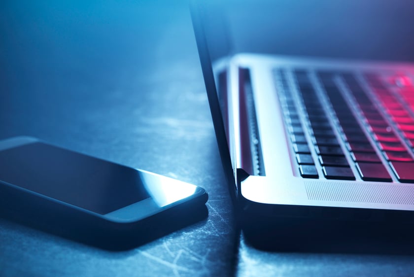 Smartphone and laptop Laptop and smartphone at night