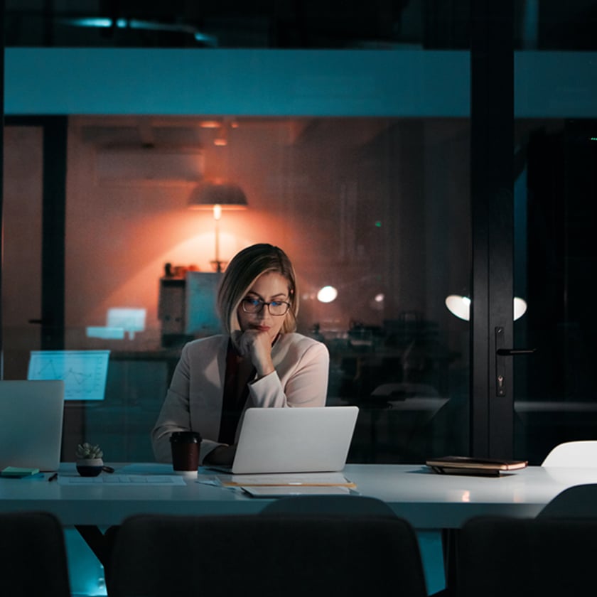 Shot of a businesswoman using a laptop at her desk during a late night at work Shot of a businesswoman using a laptop at her desk during a late night at work